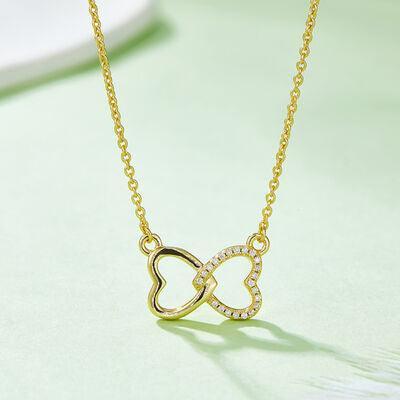 a gold necklace with a heart shaped pendant