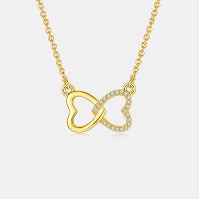 a gold necklace with a heart and a diamond