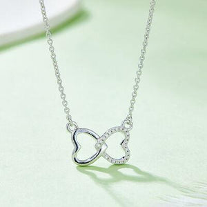 a silver necklace with a heart on it