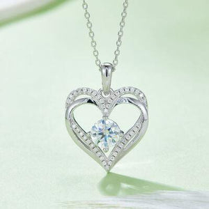 a heart shaped necklace with a diamond center