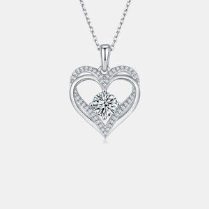 a heart shaped pendant with a diamond in the center