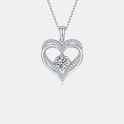 a heart shaped pendant with a diamond in the center