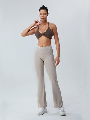 a woman in a bra top and pants posing for a picture