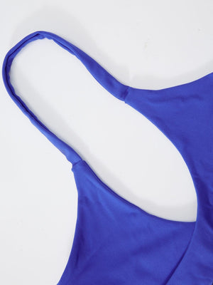 a close up of a blue top on a white surface
