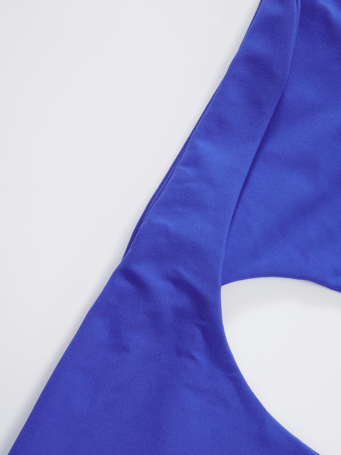 a close up of a blue top on a white surface
