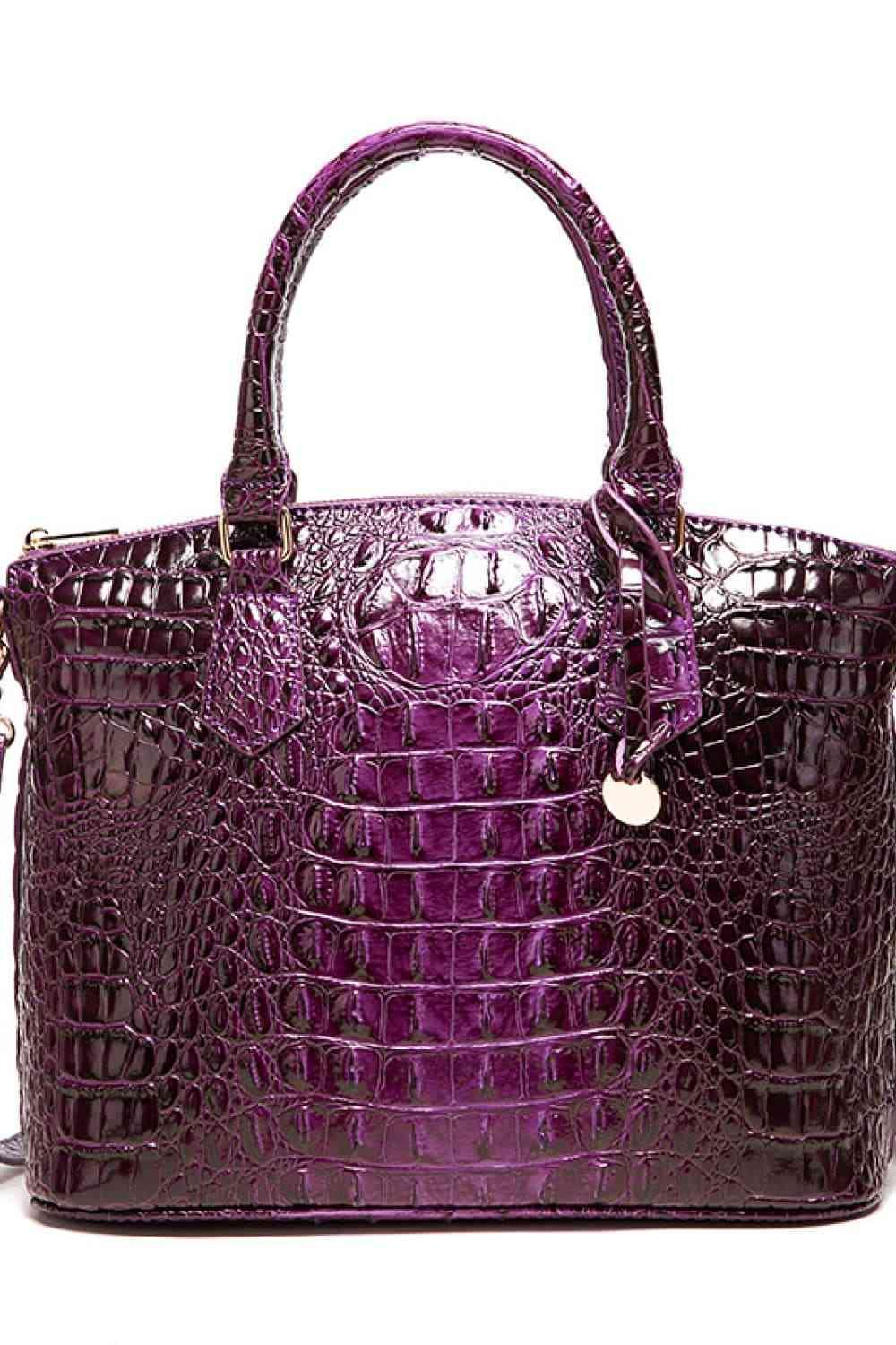 a purple handbag is shown on a white background