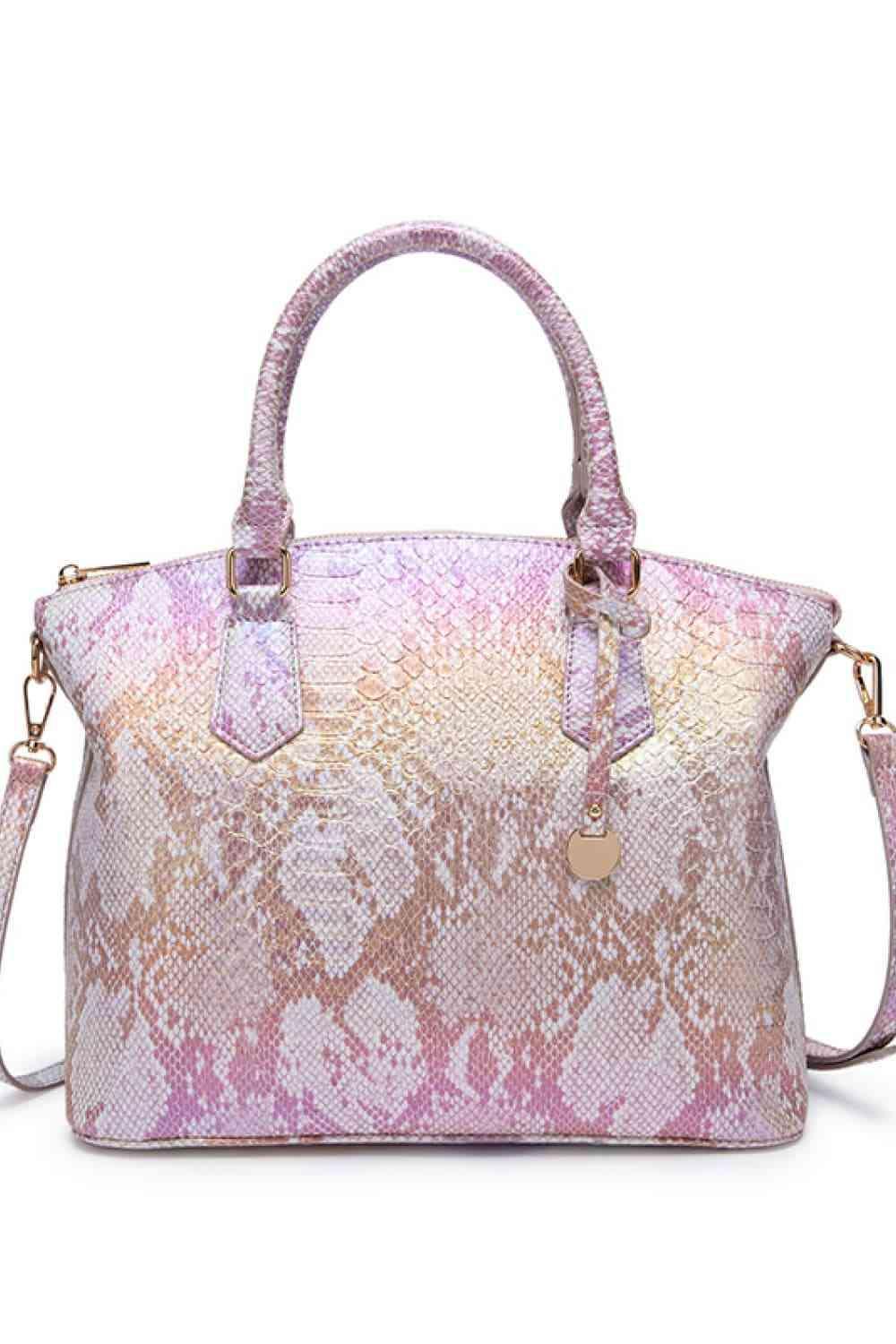 a pink and white handbag with a snake skin pattern