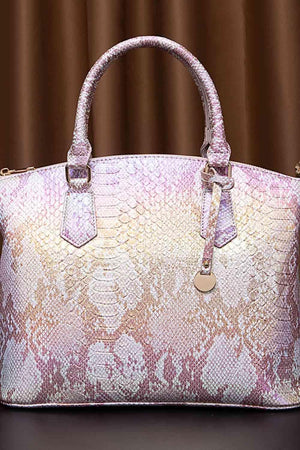 a pink and white purse sitting on top of a table