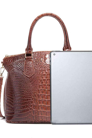 a handbag and a laptop on a white background