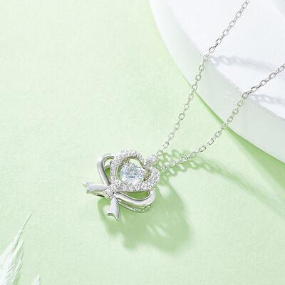 a necklace with a heart and a bow on it