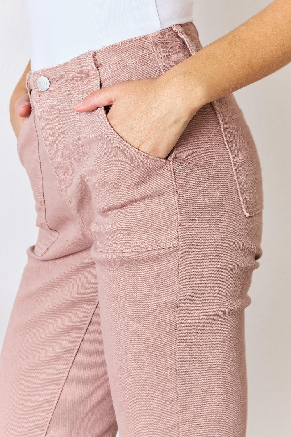 a woman wearing pink pants and a white shirt