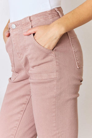 a woman wearing pink pants and a white shirt