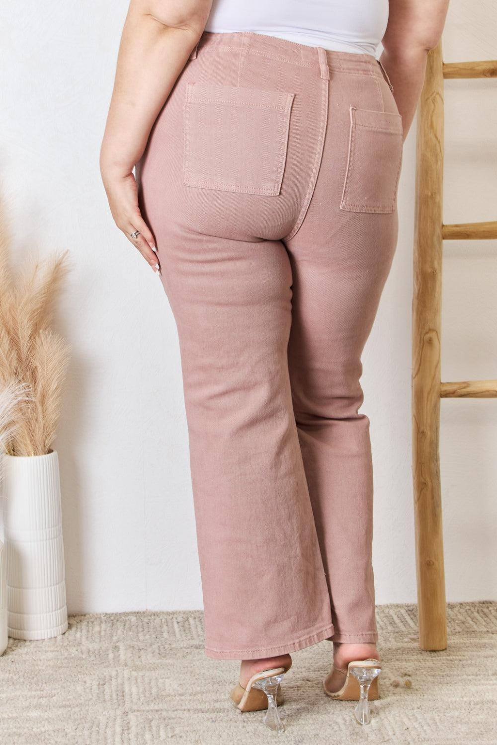 a woman in a white tank top and pink pants