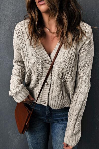 a woman wearing a white sweater and jeans