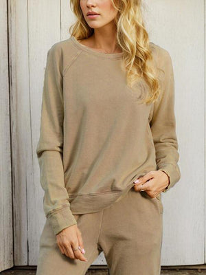 a woman standing in front of a white wall