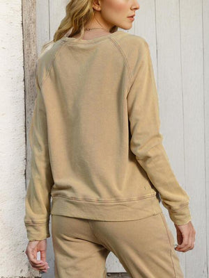 a woman standing in front of a white wall