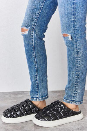 a person standing on top of a pair of jeans