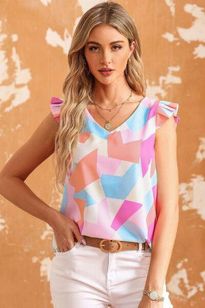 a woman in white pants and a colorful top