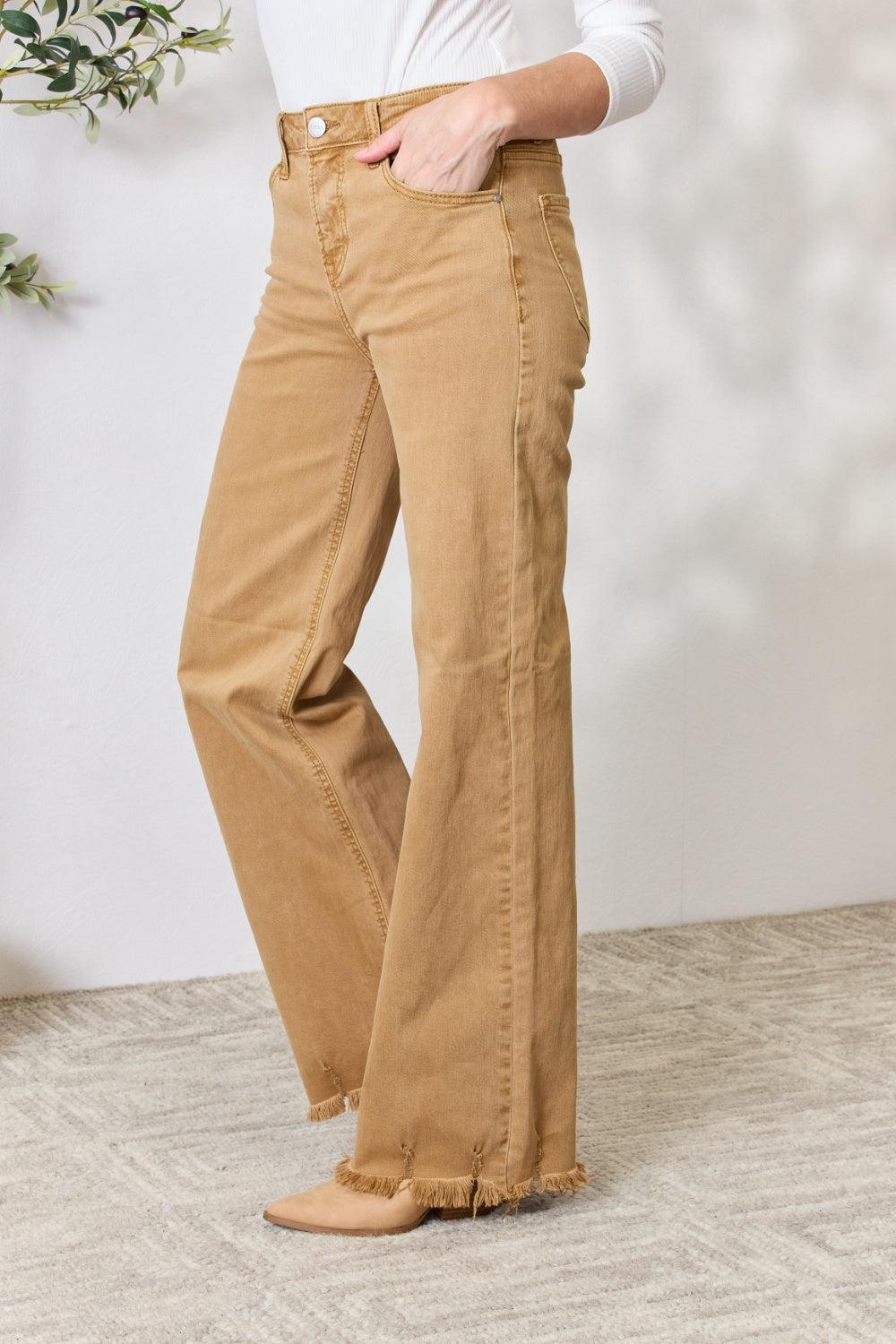 a woman in a white shirt and tan pants