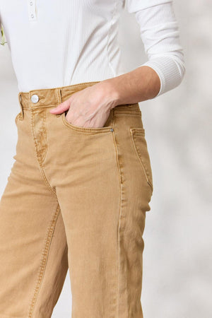 a woman wearing a white shirt and tan pants