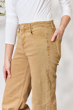 a person wearing a white shirt and tan pants