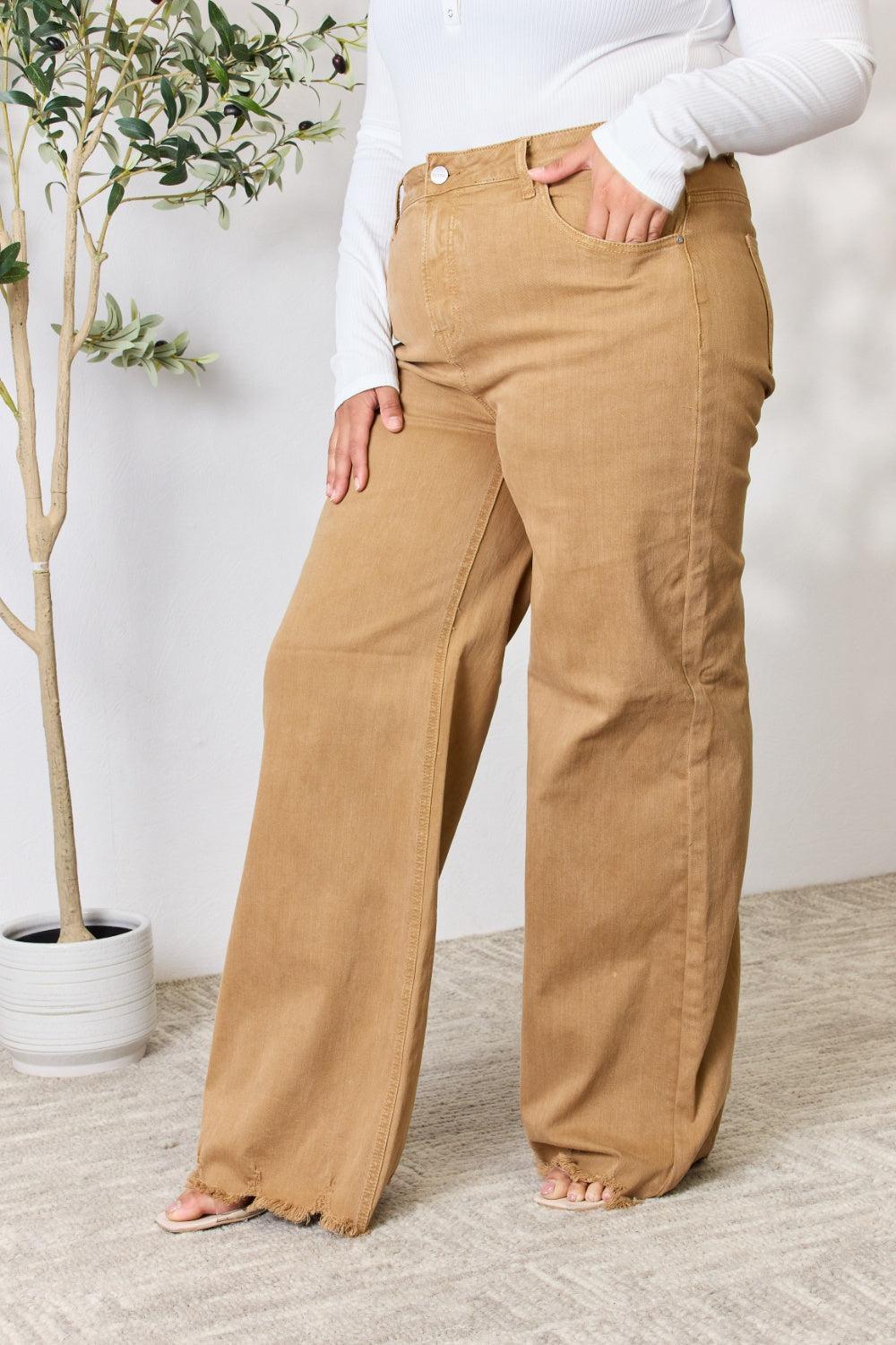 a woman standing in front of a potted plant