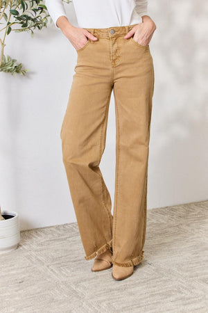 a woman in a white top and tan pants