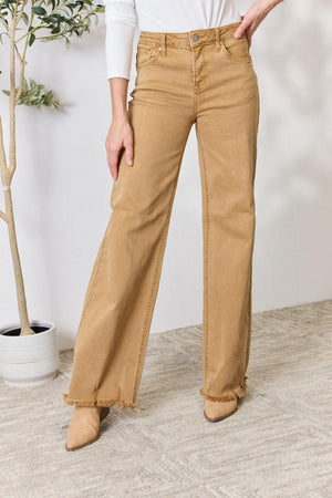 a woman in a white shirt and tan pants