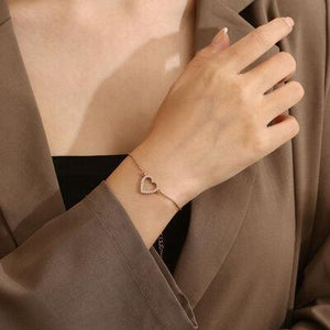 a woman wearing a heart shaped bracelet