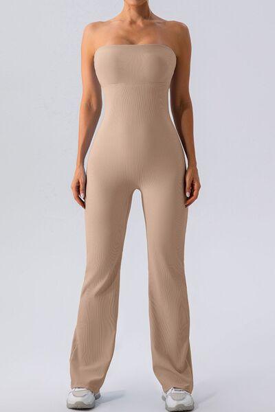 a woman in a tan bodysuit posing for the camera