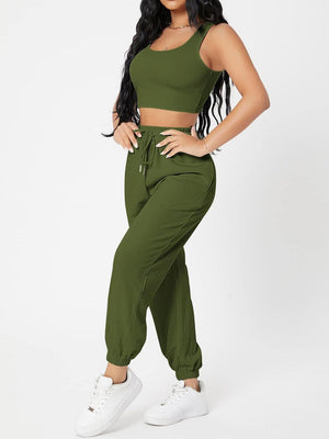 a woman wearing a crop top and pants