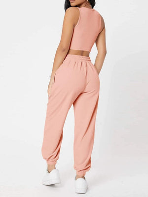 a woman in a pink top and pants