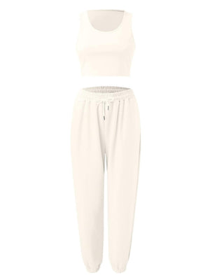 a woman wearing a white top and pants