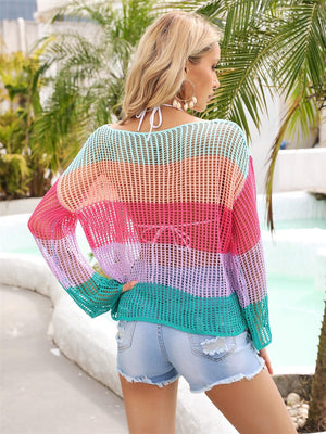 a woman wearing a colorful sweater and shorts