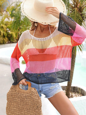 a woman wearing a hat and a colorful sweater