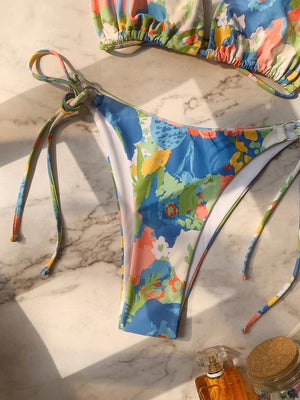 a bikini top and a bottle of honey on a marble counter