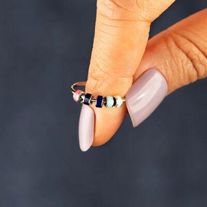 a woman's hand with a ring on it