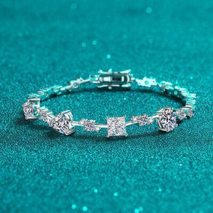 a close up of a diamond bracelet on a blue surface