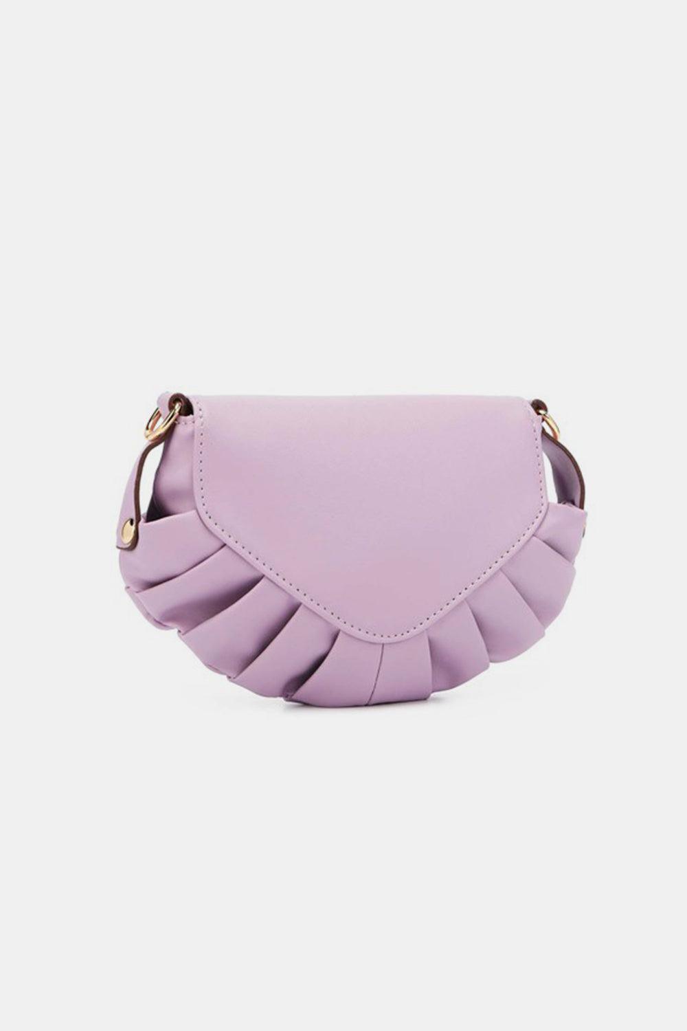 a small purple purse with a tasselled handle