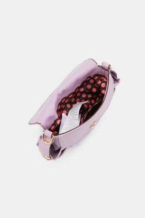 a pink handbag with polka dots on it