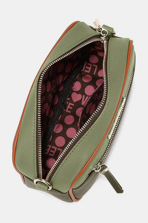 a green purse with a polka dot print on it