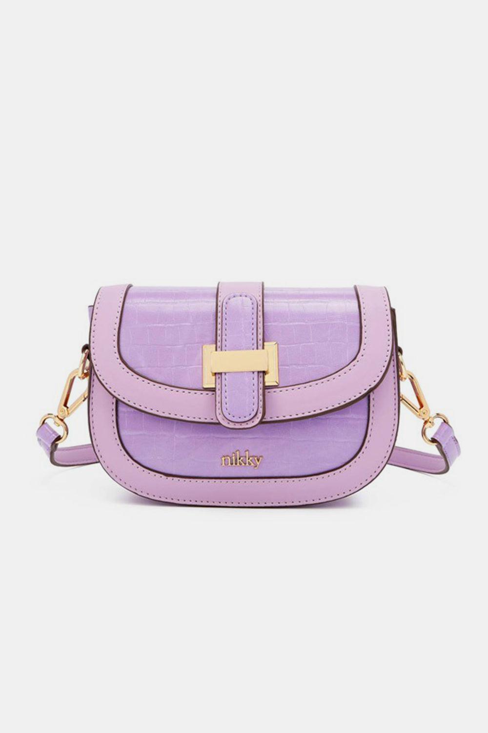 a small purple purse with a gold buckle