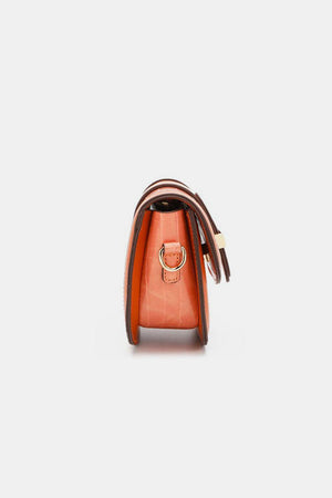 a small orange purse with a handle
