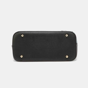 a black purse with gold studs on the front