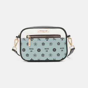 a blue and white cross body bag with flowers on it