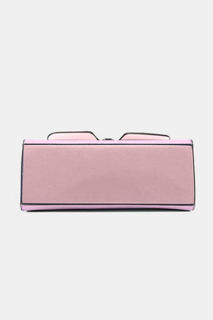 a pink purse with a pair of glasses on top of it