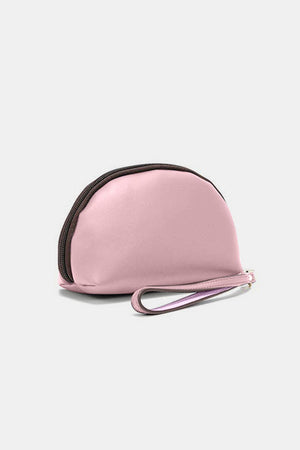 a small pink purse sitting on top of a white table