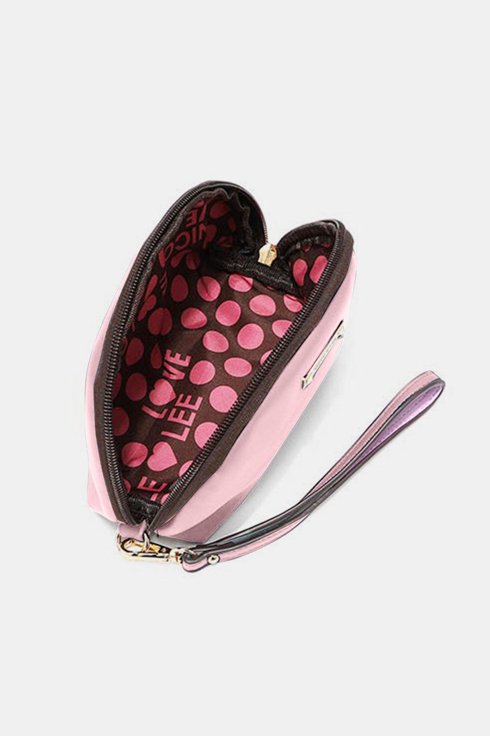 a pink heart shaped purse with a purple strap