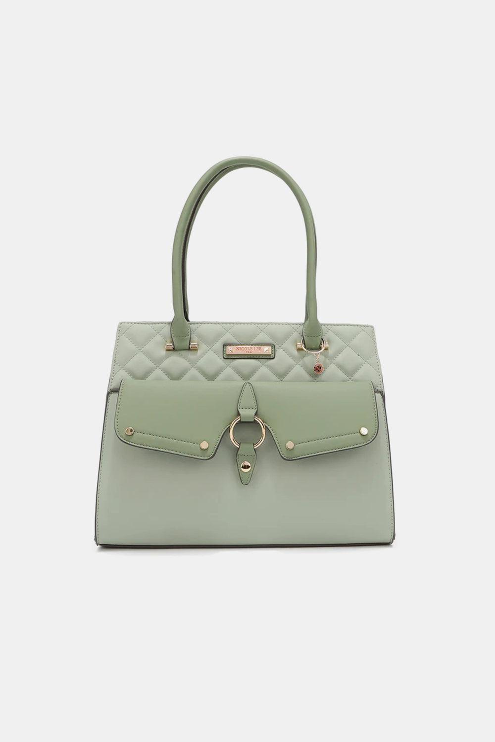 a light green handbag with a metal handle