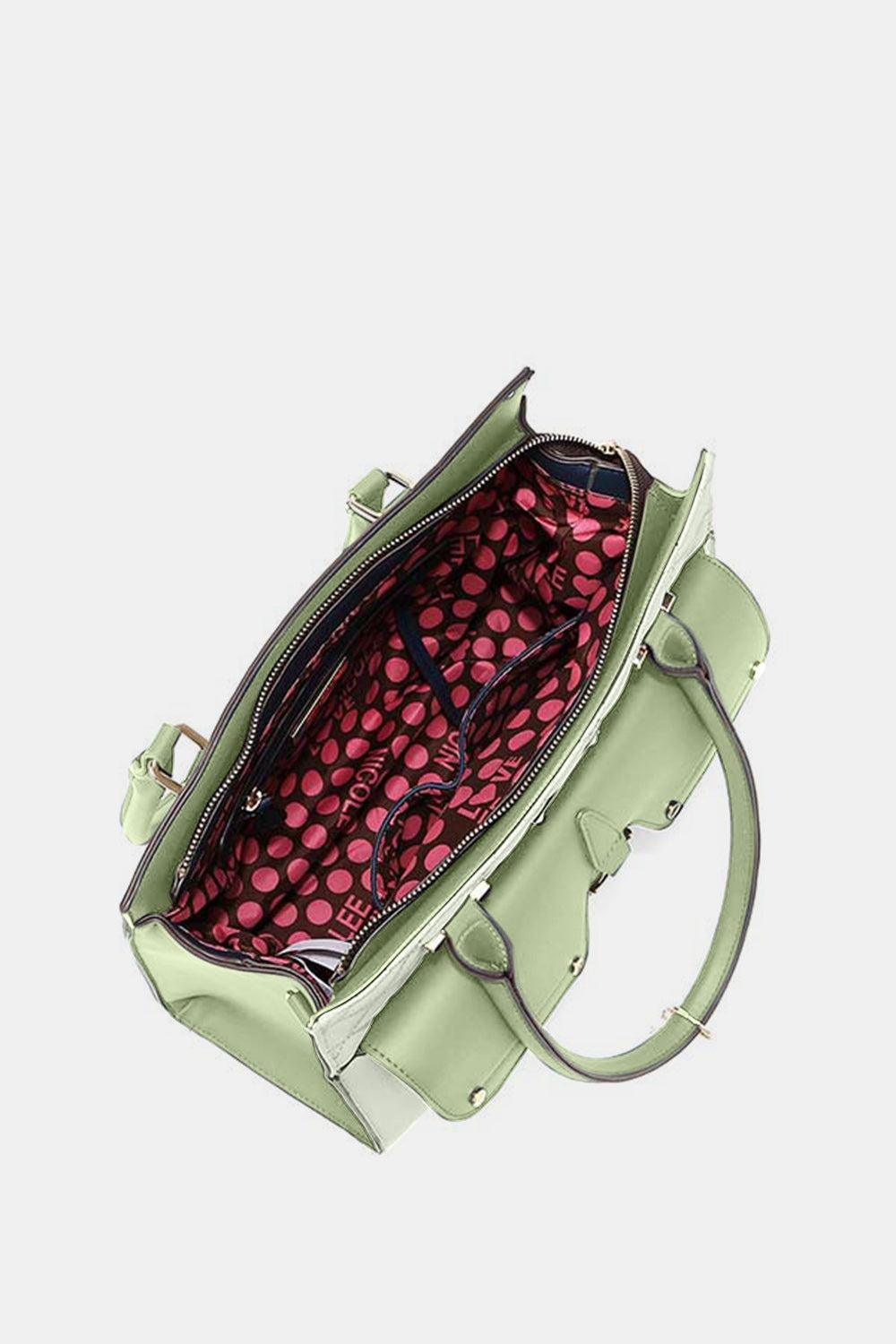 a green handbag with a pink polka dot pattern